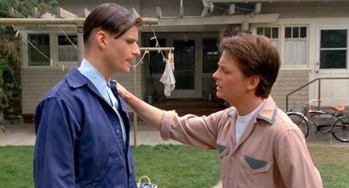 Marty McFly (Michael J. Fox) gives his father (Crispin Glover) tips on how to pick up his Mom. 